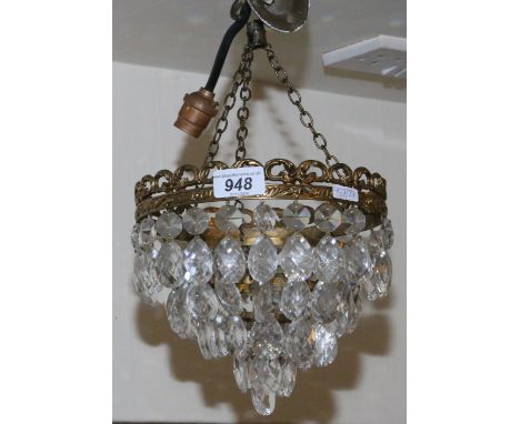 A brass and cut crystal bag chandelier.