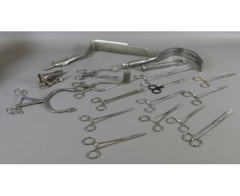 A collection of stainless steel surgical tools, stretchers and clamps.
