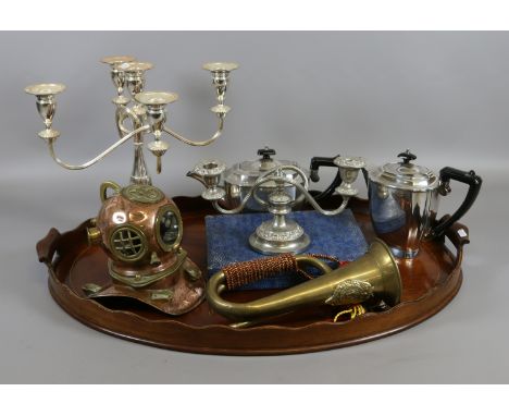 An inlaid mahogany oval butlers tray and mixed metalwares including silver plate, brass bugle and a miniature divers helmet.