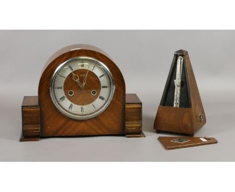 A Smiths Enfield walnut cased mantel clock along with a German oak cased metronome.