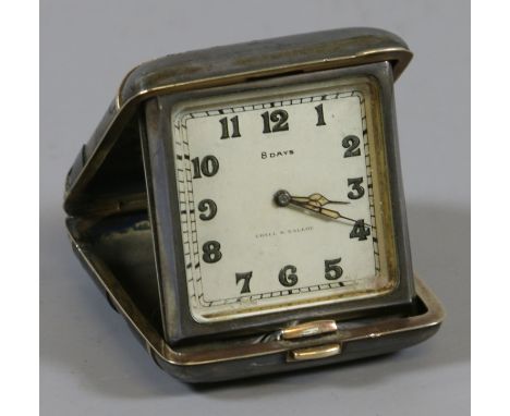 An Art Deco eight day folding bedside timepiece.  Condition Report. To be used as a guide only. Working. Outer enamel case wi