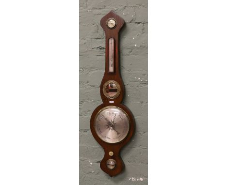 A 19th century mahogany banjo barometer with onion terminals and silvered dials. 