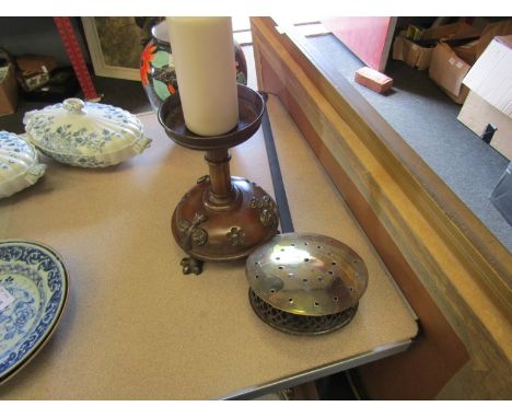 A heavy metal candlestick of Gothic form on footed base and a brass chestnut warmer 