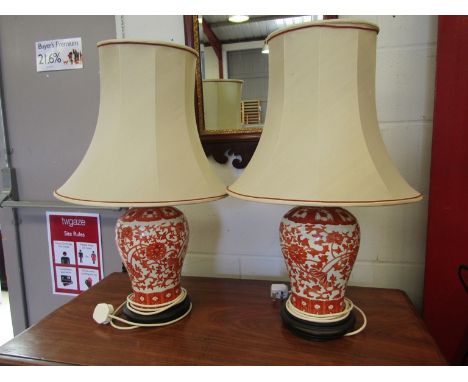 A pair of Oriental china table lamp bases of vase form, ochre coloured foliate design on a white ground