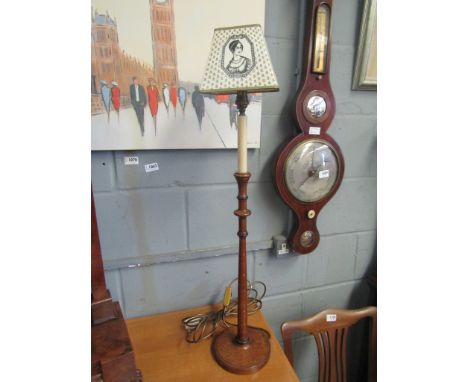 A slender oak table lamp with card shade printed with Nelson Josephine and trophies, 80cm tall