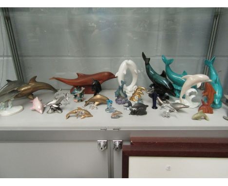 A large selection of Dolphin figures including Coalport, Goebel, brass etc