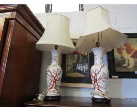 A pair of Oriental table lamp bases of vase form, blossoming tree design, on hardwood bases