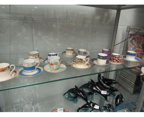 A Royal Crown Derby coffee can and saucer in the Imari palette together with 12 other decorative coffee cans and saucers incl