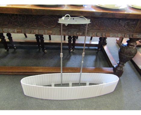 A modern ceiling light with oval pleated shade