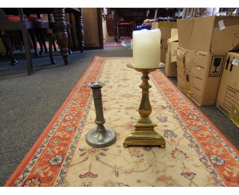 A French pewter candlestick circa 1880 and a brass church stick candle  (2)