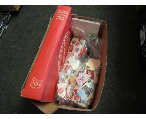 A box containing an album and a quantity of loose stamps including vintage examples