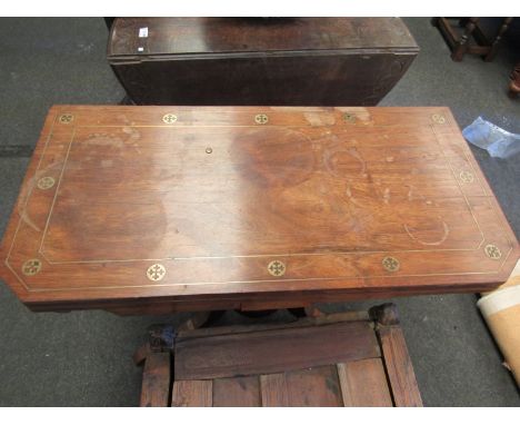 A walnut card table with canted corners and brass inlay on scroll quarter form base, 90cm wide