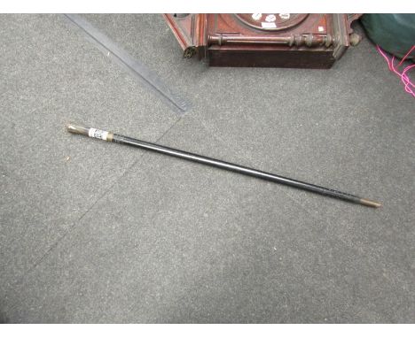 An ebonised and bone sword stick with copper lion design knop and horn handle 