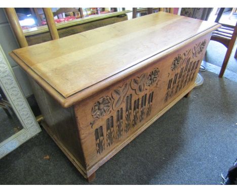A 20th Century light oak carved front chest on bracket feet, 92cm wide x 46cm high x 39cm deep