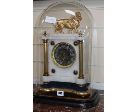 An alabaster clock surmounted with a lion, under glass dome