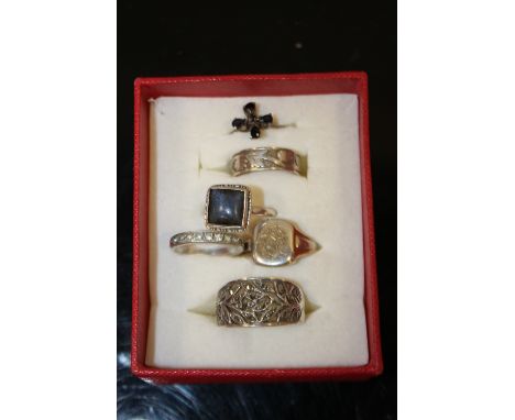 A BOX CONTAINING SIX SILVER DRESS RINGS