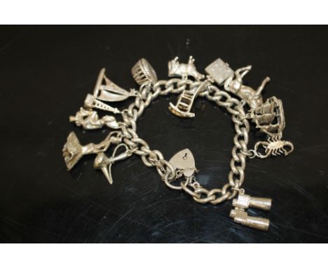 A SILVER CHARM BRACELET WITH LARGE SILVER CHARMS 