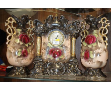 A VINTAGE CERAMIC CLOCK WITH GARNITURE