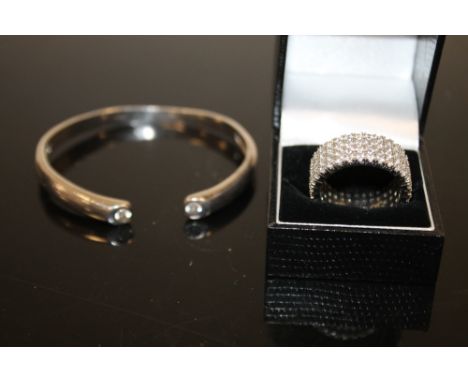 A HALLMARKED SILVER GEMSET BANGLE TOGETHER WITH LARGE SILVER RING (2) 