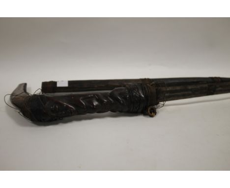 VINTAGE TRIBAL ART CURVED HANDLED SWORD WITH CARVED FIGURED DETAIL IN WOODEN SHEATH 