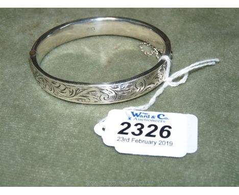 A hollow Silver Bangle with engraved decoration, 1/2" wide.