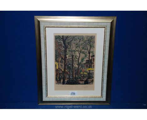 A framed and mounted print of a Paris street scene, indistinctly signed lower right.