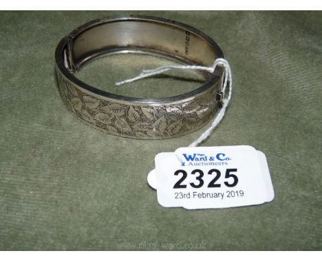 A single skin Silver Bangle with engraved decoration, 3/4" wide.