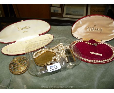 A Sigma pearl necklace and a Rosita pearl necklace with miscellaneous compacts.