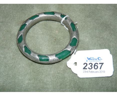A Chinese Jade Bangle mounted in white metal surround.