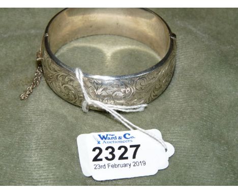 A hollow Silver Bangle with engraved decoration, 1" wide.