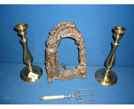 A pair of brass 'classical' Candlesticks, small toasting fork and a metal picture frame 'Freedom'.