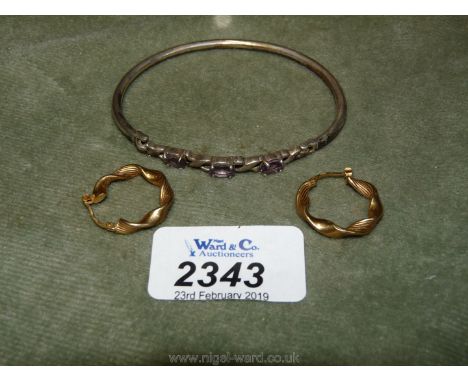 A pair of 9ct gold twist Earrings and a silver Bangle set with amethysts.