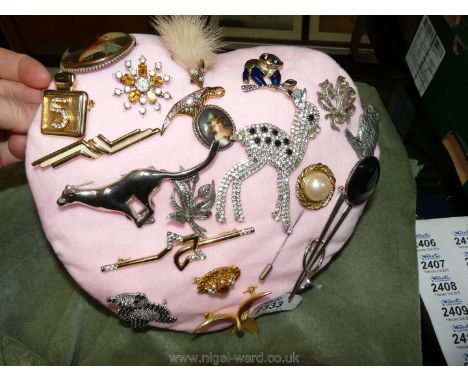 Twenty assorted brooches including Adrien Mann, Corocraft, mounted on a cushion