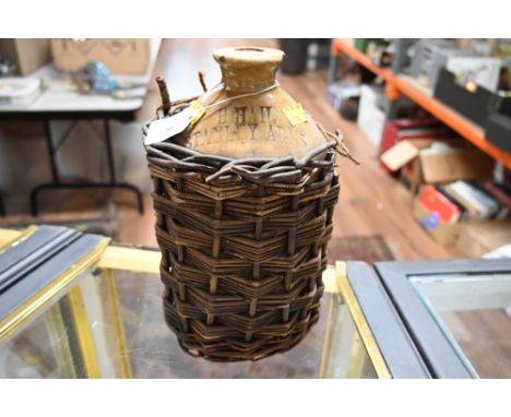 A vintage H. Hail Stanley Arms flagon in basket surround 
