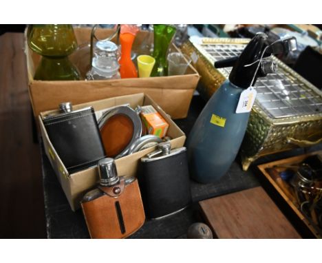 A vintage sparklets siphon together with a box of hip flasks 