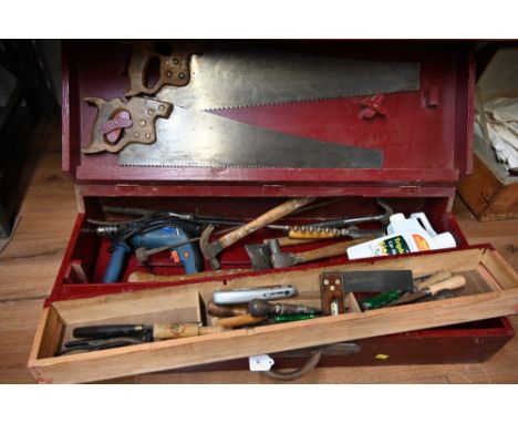 A red painted tool chest containing tools 