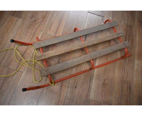 A vintage red metal sledge 