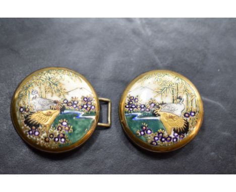 An Oriental Satsuma porcelain two piece belt buckle, each circular piece with enamel and gilt scenic panels depicting cranes