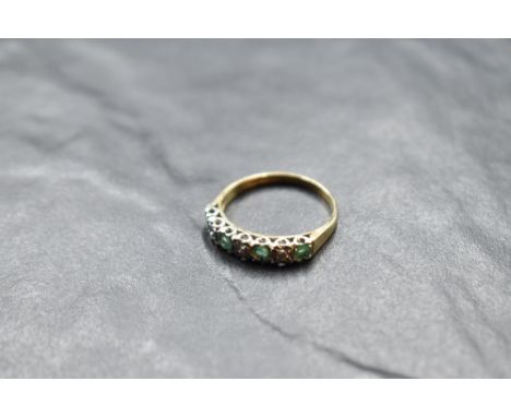 An emerald and diamond half eternity ring having an illusionary setting on a 9ct gold loop, size R &amp; approx 2.4g