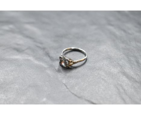 An Art Deco style diamond solitaire ring, approx 1.5ct in a square mount having diamond set shoulders on a white metal loop s