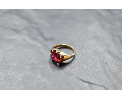 A yellow metal signet ring set with a square ruby, approx 1.5ct in a multi claw mount, no marks but ring thought to be Indian