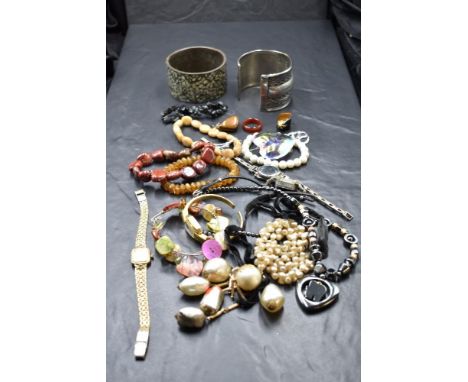 A selection of jewellery including white metal cuff bangle, ethnic style bangle, hematite necklace, vintage wrist watches, po