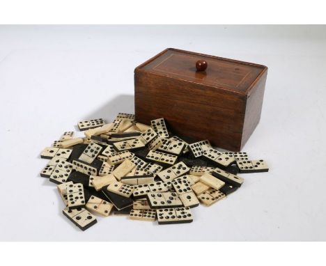 A 19th century mahogany and boxwood inlaid tea caddy, with lift up lid and metal liner, housing bone and ebony dominoes, 16cm