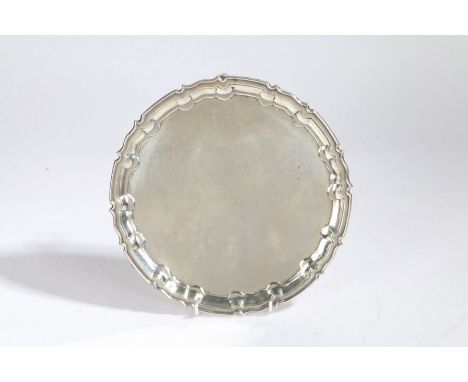 An Elizabeth II silver salver, Sheffield 1960, maker William Hutton &amp; Sons Ltd. with pie crust rim, raised on three acant