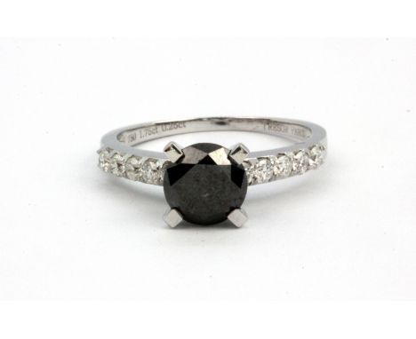 An 18ct white gold solitaire ring set with a 1.75ct brilliant cut black diamond and diamond set shoulders, (N.5).