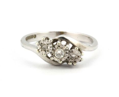 A 9ct white gold three diamond set ring, (O)