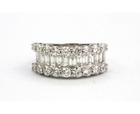 An 18ct white gold (stamped 750) ring set with baguette and brilliant cut diamonds, approx. 2.9ct overal, (N).