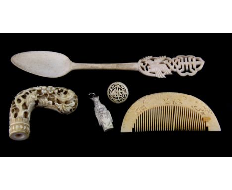 An early carved ivory walking stick handle, Chinese bone spoon and comb.