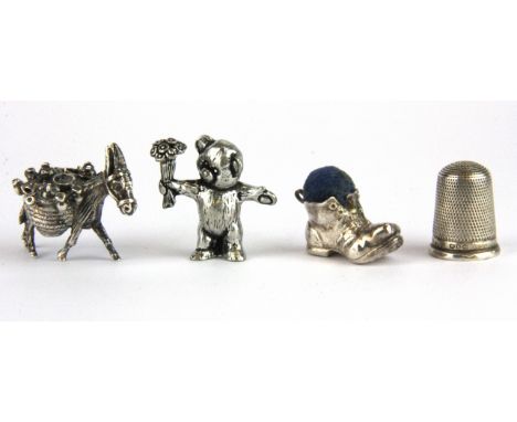 A 925 silver model of a donkey together with a .960  silver figure of a teddy bear, a hallmark silver boot pin cushion and a 