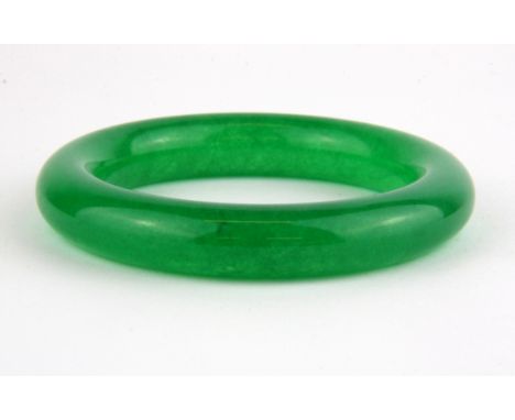 A Chinese carved jade bangle, Dia. 8.5cm.